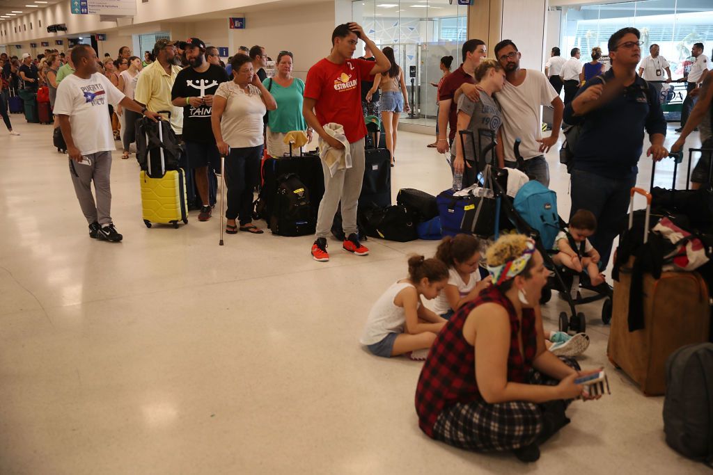 People wait in line to get a flight at the Luis Munoz Marin International Airport after Hurricane Maria passed through the island last week on September 25, 2017 in San Juan, Puerto Rico.  (Photo by Joe Raedle/Getty Images)